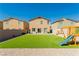 Home backyard with artificial turf, playground and gravel at 7322 Glimmer Point St, North Las Vegas, NV 89084