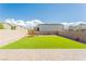 Home backyard with artificial turf, playground and gravel at 7322 Glimmer Point St, North Las Vegas, NV 89084