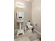 Well-lit powder room featuring a pedestal sink and toilet at 7322 Glimmer Point St, North Las Vegas, NV 89084