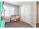 Bedroom with a large window, closet, and a comfortable bed at 7322 Glimmer Point St, North Las Vegas, NV 89084