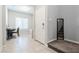 Inviting foyer with gray walls, tiled floors, a convenient stairway, and home office setup at 7322 Glimmer Point St, North Las Vegas, NV 89084