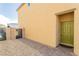 View of a modern home's side entrance with a secure gate and low-maintenance gravel landscaping at 7322 Glimmer Point St, North Las Vegas, NV 89084