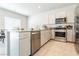 Bright kitchen featuring stainless steel appliances and gray cabinets at 7322 Glimmer Point St, North Las Vegas, NV 89084