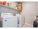 Bright laundry room with a full-size, side-by-side washer and dryer set at 7322 Glimmer Point St, North Las Vegas, NV 89084