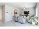 Inviting living room featuring tile flooring, neutral decor, and a seamless flow to other areas at 7322 Glimmer Point St, North Las Vegas, NV 89084