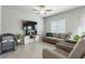 Spacious living room featuring tile floors, a ceiling fan, and neutral decor for versatile styling at 7322 Glimmer Point St, North Las Vegas, NV 89084