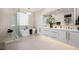 Bright bathroom featuring double sinks, standalone soaking tub and modern finishes at 8455 Turtle Creek Cir, Las Vegas, NV 89113