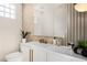 Modern bathroom featuring sleek fixtures, a decorative mirror, and stylish accent wall creating a serene ambiance at 8455 Turtle Creek Cir, Las Vegas, NV 89113