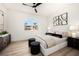 Cozy bedroom with light wood floors, large windows and contemporary decor at 8455 Turtle Creek Cir, Las Vegas, NV 89113