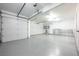 Spacious three car garage with epoxy floors, ample lighting, and built-in shelving for organization and storage at 8455 Turtle Creek Cir, Las Vegas, NV 89113