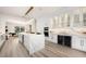 Modern kitchen with waterfall island, stainless steel appliances, sleek white cabinetry, and bright lighting at 8455 Turtle Creek Cir, Las Vegas, NV 89113