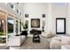 Bright living room with high ceilings and large windows offers an airy, light-filled space with modern furnishings at 8455 Turtle Creek Cir, Las Vegas, NV 89113