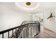 Elegant staircase with black railing and a stunning chandelier, leading to the upper level of the home at 8455 Turtle Creek Cir, Las Vegas, NV 89113