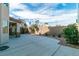 Private backyard featuring a covered patio, desert landscaping, and a brick privacy wall, perfect for outdoor relaxation at 9824 Gallo Dr, Las Vegas, NV 89147