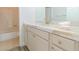 Bathroom vanity featuring white cabinets and a marbled countertop with gold fixtures and hardware at 9824 Gallo Dr, Las Vegas, NV 89147