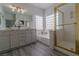 Spacious bathroom boasts dual sinks, a glass shower, and a soaking tub, perfect for relaxation at 9824 Gallo Dr, Las Vegas, NV 89147