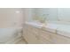 Bright bathroom features a tub/shower, elegant vanity, and refined gold fixtures at 9824 Gallo Dr, Las Vegas, NV 89147