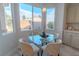 Breakfast nook with a glass table and four chairs near bright windows at 9824 Gallo Dr, Las Vegas, NV 89147