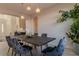 Dining room showcasing a rustic table, velvet chairs and modern lighting at 9824 Gallo Dr, Las Vegas, NV 89147