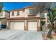 Beautiful two-story home showcasing a three car garage, desert landscaping, and a charming front entrance at 9824 Gallo Dr, Las Vegas, NV 89147