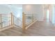 Bright hallway with wood floors and modern metal and wood banister at 9824 Gallo Dr, Las Vegas, NV 89147