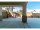 Inviting covered patio offers a serene view of the well-maintained backyard with desert landscaping and privacy wall at 9824 Gallo Dr, Las Vegas, NV 89147