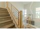 Modern wooden staircase with steel railings and stylish décor with lots of natural light at 9824 Gallo Dr, Las Vegas, NV 89147