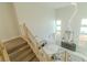 Bright, modern staircase with wood treads and metal railings, complemented by tall ceilings at 9824 Gallo Dr, Las Vegas, NV 89147