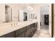 Bathroom featuring dual sinks, dark wood cabinetry, and tile flooring at 1 Grand Masters Dr, Las Vegas, NV 89141