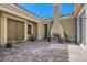 Charming courtyard featuring a fireplace, paver flooring, and a tranquil outdoor seating area at 1 Grand Masters Dr, Las Vegas, NV 89141