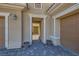 Inviting front entry featuring a paver driveway, double garage doors, and a glimpse of the courtyard at 1 Grand Masters Dr, Las Vegas, NV 89141