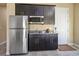 Kitchenette area with stainless steel refrigerator and granite countertops at 1 Grand Masters Dr, Las Vegas, NV 89141