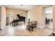 Spacious living room featuring neutral walls, tile flooring, and a grand piano at 1 Grand Masters Dr, Las Vegas, NV 89141