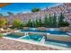 Backyard featuring a pool, spa, and rock wall at 1 Grand Masters Dr, Las Vegas, NV 89141