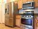 Kitchen featuring stainless steel microwave, oven, and wood cabinets at 10001 Peace Way # 2353, Las Vegas, NV 89147