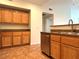 Kitchen featuring stainless steel dishwasher, sink, and wood cabinets at 10001 Peace Way # 2353, Las Vegas, NV 89147