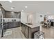 Modern kitchen featuring granite countertops, stainless steel appliances, and dark wood cabinets at 101 Deseo Ct, North Las Vegas, NV 89031