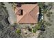 Aerial view of a terra cotta tiled roof, desert landscaping, and a private outdoor patio at 1150 Calcione Dr, Henderson, NV 89011