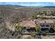 An aerial view of the property showcasing its red tile roof, private patio, and surrounding desert landscape at 1150 Calcione Dr, Henderson, NV 89011