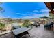 Outdoor patio space with comfortable seating, a grill, and stunning views of the surrounding hills at 1150 Calcione Dr, Henderson, NV 89011