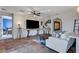 Bright living room with tiled floors, a large TV, modern decor, and adjacent bedroom view at 1150 Calcione Dr, Henderson, NV 89011