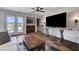 Open living room featuring stone flooring, a ceiling fan, and sliding doors to the exterior at 1150 Calcione Dr, Henderson, NV 89011