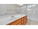 Bathroom with a double sink vanity, a large mirror, and a shower-tub combo at 1709 Guthrie Dr, Las Vegas, NV 89117