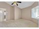 Carpeted bedroom featuring neutral walls, a ceiling fan, and a view to the ensuite bathroom at 1709 Guthrie Dr, Las Vegas, NV 89117