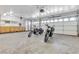 Spacious garage with motorcycles, a workbench, storage cabinets, and multiple garage doors at 1709 Guthrie Dr, Las Vegas, NV 89117