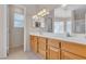 Bright main bathroom with dual sinks, great lighting and a large mirror at 1709 Guthrie Dr, Las Vegas, NV 89117