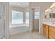 Bright main bathroom with a separate tub and shower, plus natural light at 1709 Guthrie Dr, Las Vegas, NV 89117