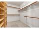 Bright walk-in closet featuring custom wooden shelving and ample storage space at 1709 Guthrie Dr, Las Vegas, NV 89117