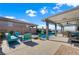 Relaxing backyard retreat with a covered patio, swimming pool, fire pit, and ample seating area at 181 Sierra Alta Pl, Henderson, NV 89015