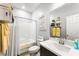 Clean bathroom with tub/shower combination, white subway tile, floating shelves, and modern vanity at 181 Sierra Alta Pl, Henderson, NV 89015